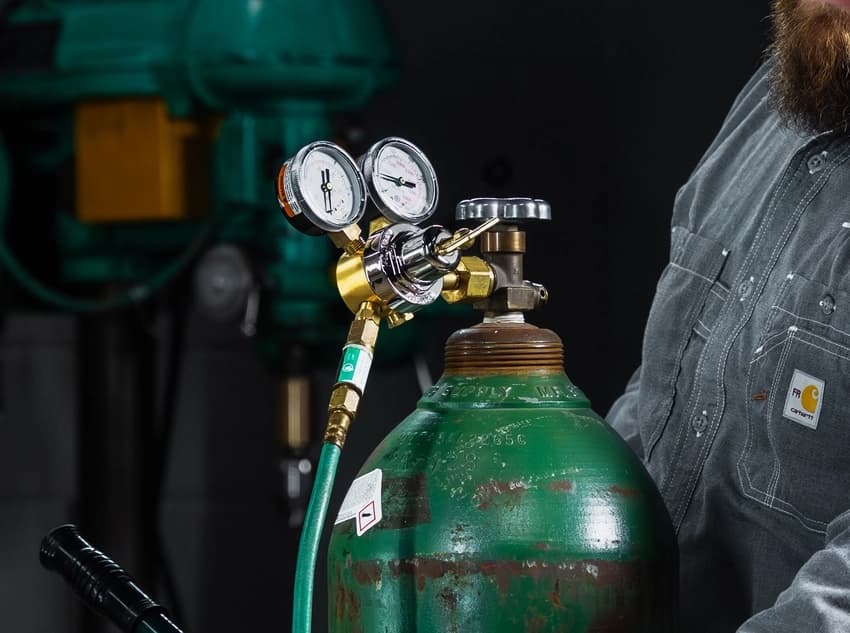 Kevin adjusting Smith regulator and checking for leaks.