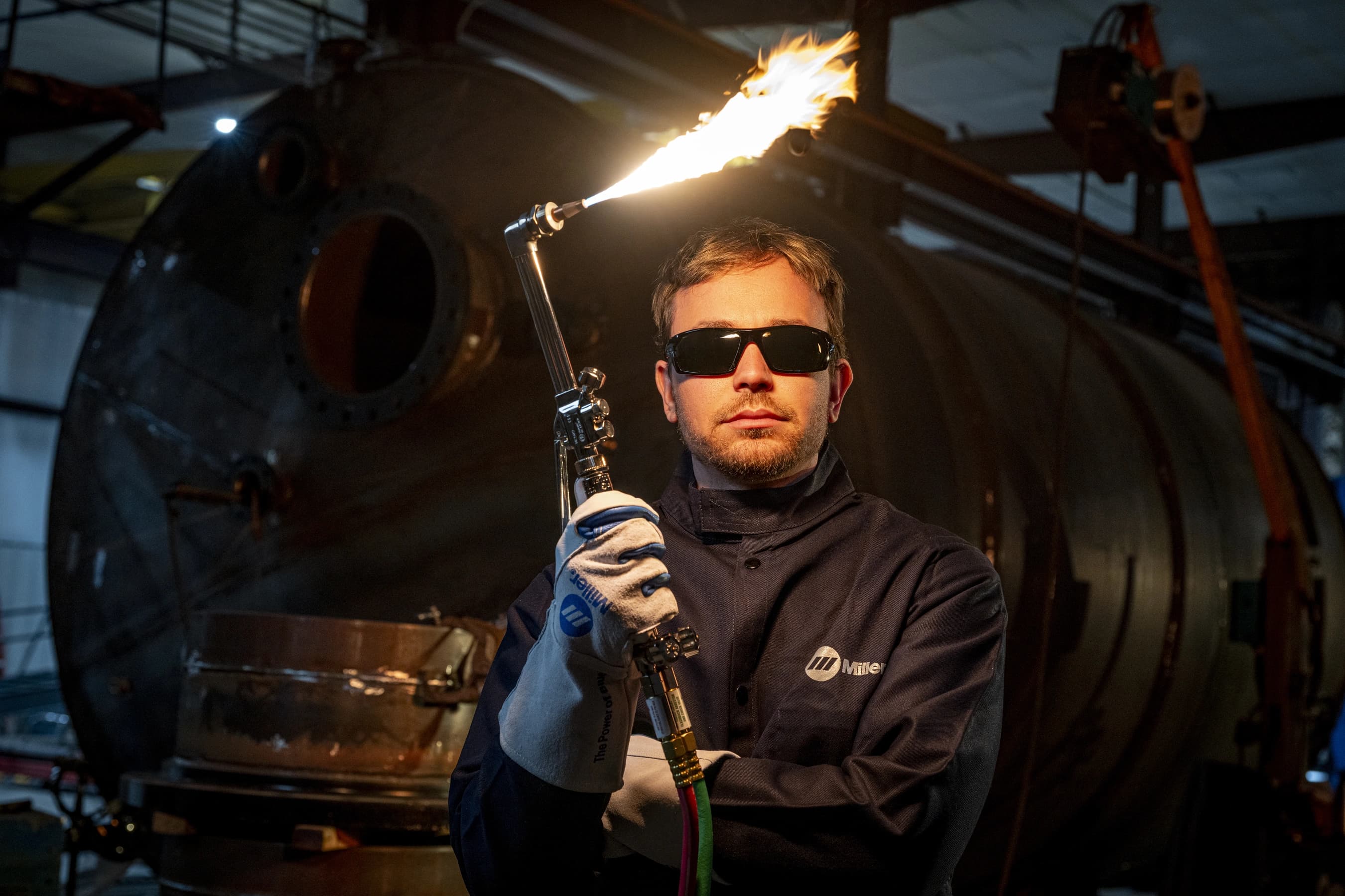 Portrait of gentleman in shop holding lit torch